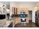 Bright kitchen showcasing granite countertops, stainless steel appliances, and light wood cabinets for storage at 1668 Rosemary Dr, Castle Rock, CO 80109