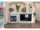 Bright living room with a stone fireplace and built-in shelving and arched alcove at 1668 Rosemary Dr, Castle Rock, CO 80109
