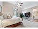 Spacious main bedroom with a ceiling fan, large window, and a view into the bathroom at 1668 Rosemary Dr, Castle Rock, CO 80109