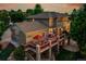 Aerial view showcasing a large backyard with a spacious deck, outdoor dining area, and lush landscaping at 24965 E Roxbury Pl, Aurora, CO 80016