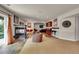 Open basement with fireplace, comfortable lounge area, and wet bar exudes a relaxing vibe at 24965 E Roxbury Pl, Aurora, CO 80016