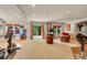 Spacious basement featuring home gym, fireplace, and lounge areas, perfect for entertainment at 24965 E Roxbury Pl, Aurora, CO 80016