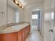 Bathroom features a double sink vanity with cherry cabinets and a connecting door to the shower at 24965 E Roxbury Pl, Aurora, CO 80016