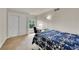 Bright bedroom with a blue floral comforter, adjacent desk, and closet offers a serene living space at 24965 E Roxbury Pl, Aurora, CO 80016