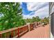 Spacious deck featuring stone accents, a patio heater, and outdoor seating under an umbrella for relaxing and entertaining at 24965 E Roxbury Pl, Aurora, CO 80016