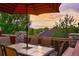 Cozy deck features an umbrella-covered table and chairs offering stunning views of the surrounding landscape at 24965 E Roxbury Pl, Aurora, CO 80016