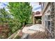 Two-story home featuring a stone patio and deck with lush landscape and mature trees surrounding the property at 24965 E Roxbury Pl, Aurora, CO 80016