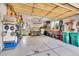 Spacious two-car garage with ample storage, shelving, and workbench area for tools and equipment at 24965 E Roxbury Pl, Aurora, CO 80016