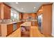 Bright kitchen with wood cabinets, stainless appliances, large window and eat-in breakfast area at 24965 E Roxbury Pl, Aurora, CO 80016