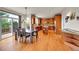 Eat-in kitchen features hardwood floors, a central island, and glass door access to a patio at 24965 E Roxbury Pl, Aurora, CO 80016