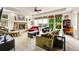 Bright living room with stone fireplace, large windows, and a ceiling fan at 24965 E Roxbury Pl, Aurora, CO 80016