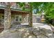 Covered patio featuring stone pillars and flagstone flooring, perfect for outdoor entertaining at 24965 E Roxbury Pl, Aurora, CO 80016