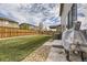 Well-manicured backyard with lush green grass, a wooden fence, and rock landscaping at 25621 E Cedar Pl, Aurora, CO 80018