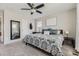 Cozy bedroom featuring a patterned bedspread, ceiling fan, and carpeted floors at 25621 E Cedar Pl, Aurora, CO 80018