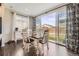 Bright dining area with a table set for four, large windows overlooking the backyard, and dark wood floors at 25621 E Cedar Pl, Aurora, CO 80018