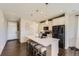 Modern kitchen with white cabinets, a center island with seating, stainless steel appliances, and stylish lighting at 25621 E Cedar Pl, Aurora, CO 80018