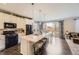 Modern kitchen featuring a large island with seating, stainless steel appliances, and stylish pendant lighting at 25621 E Cedar Pl, Aurora, CO 80018