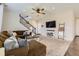 Inviting living room featuring a plush brown sectional sofa, ceiling fan, and a modern entertainment center at 25621 E Cedar Pl, Aurora, CO 80018