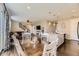 Inviting living room and kitchen area with dark wood floors, a kitchen island, and a comfortable seating area at 25621 E Cedar Pl, Aurora, CO 80018