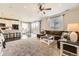 Open-concept living area with a plush brown sofa, kitchen island seating, and a dining area with natural light at 25621 E Cedar Pl, Aurora, CO 80018