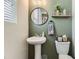 Charming powder room with a pedestal sink, modern fixtures, and stylish decor at 25621 E Cedar Pl, Aurora, CO 80018