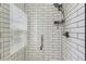 Contemporary shower featuring white subway tile and modern fixtures at 25621 E Cedar Pl, Aurora, CO 80018