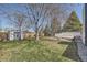 Large backyard with storage shed, white fence and mature trees, offering a serene and private outdoor space at 5485 E Bails Dr, Denver, CO 80222