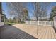 Outdoor deck and fenced-in yard, perfect for gatherings and enjoying the spacious green area surrounded by mature trees at 5485 E Bails Dr, Denver, CO 80222