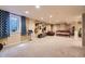 Finished basement featuring guitars on display and comfortable seating area with natural light from the window at 5485 E Bails Dr, Denver, CO 80222