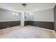 Basement featuring carpet, white trim, gray walls, and two windows for natural light at 5485 E Bails Dr, Denver, CO 80222