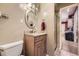 Well-lit bathroom with a granite countertop, decorative mirror, and a view to the stand-up shower at 5485 E Bails Dr, Denver, CO 80222