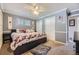 Comfortable bedroom featuring carpet, crown molding, two closets, and a ceiling fan at 5485 E Bails Dr, Denver, CO 80222