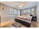 Cozy bedroom featuring neutral paint, carpet, ceiling fan, and windows with light-filtering shutters at 5485 E Bails Dr, Denver, CO 80222