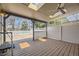 Covered back deck featuring wood flooring, privacy lattice, fan, and lighting, perfect for outdoor entertaining at 5485 E Bails Dr, Denver, CO 80222