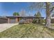 Charming brick home featuring mature landscaping and a well-manicured lawn at 5485 E Bails Dr, Denver, CO 80222