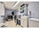 This laundry room is equipped with a stainless steel washer and dryer, ample counter space, and utility sink at 5485 E Bails Dr, Denver, CO 80222