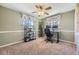 Home office featuring neutral paint, carpet, windows, and a ceiling fan at 5485 E Bails Dr, Denver, CO 80222