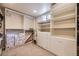 Spacious walk-in closet features custom shelving, drawers, and hanging rods for optimal organization and storage at 5485 E Bails Dr, Denver, CO 80222