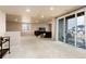 Open basement featuring a sitting area, walkout sliding glass door to patio and window at 6657 S Kline Way, Littleton, CO 80127