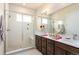 Beautiful bathroom featuring a glass-enclosed shower and double vanity sinks at 6657 S Kline Way, Littleton, CO 80127