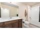 Bathroom boasts a spacious vanity, and a shower-tub combo with white tile surround at 6657 S Kline Way, Littleton, CO 80127