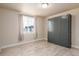 Cozy bedroom is staged as multi-use flex space with a murphy bed and wood floors at 6657 S Kline Way, Littleton, CO 80127