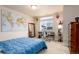 This bedroom features a world map wall hanging and a desk area by the window at 6657 S Kline Way, Littleton, CO 80127