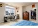 Bedroom featuring natural light, a desk area, and an organized closet space at 6657 S Kline Way, Littleton, CO 80127