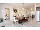 Dining room featuring elegant wooden table and bench seating, with neutral decor and luxury vinyl plank flooring at 6657 S Kline Way, Littleton, CO 80127