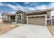 Beautiful exterior of home with a stone accents and a spacious driveway leading to the garage at 6657 S Kline Way, Littleton, CO 80127