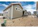 A tidy exterior side view showing attractive siding, rock landscaping, and a shared driveway at 6657 S Kline Way, Littleton, CO 80127