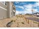 Exterior side view showing attractive siding, landscaping, and a charming wooden fence at 6657 S Kline Way, Littleton, CO 80127