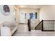 Inviting home foyer with stairs, luxury vinyl plank flooring, and modern decorations at 6657 S Kline Way, Littleton, CO 80127