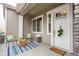 Inviting front porch with charming seating and decor, perfect for relaxing outdoors at 6657 S Kline Way, Littleton, CO 80127